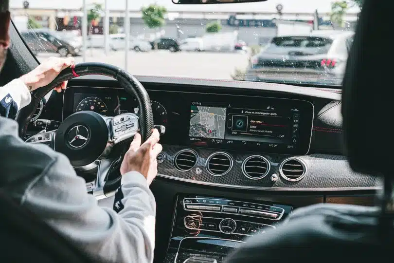 person in gray long sleeve shirt driving car