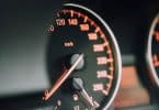 closeup photo of black analog speedometer