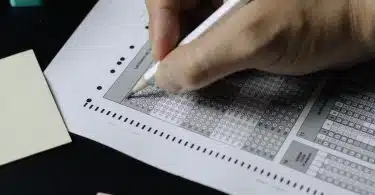 person writing on white paper